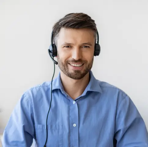 Customer service agent with headphones offering 24/7 taxi booking support for Yellow Cabs GP in Grande Prairie.